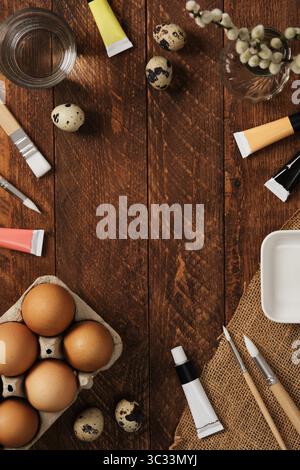 Preparation for Easter celebration. Painting Easter eggs with acrylic pigment dyes in tubes. Place for your text. Stock Photo