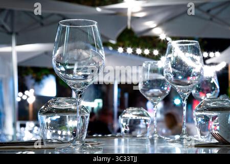 A beautiful row of wine glasses elegantly arranged on top of a table Stock Photo