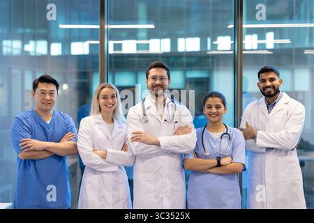A diverse group of medical professionals stands confidently, embodying teamwork and expertise in a modern healthcare setting. Stock Photo