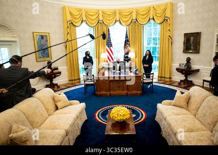March 30, 2021, Washington, District of Columbia, USA: United States President Joe Biden makes remarks prior to  signing the PPP Extension Act of 2021 into law in the Oval Office of the White House in Washington, DC, Tuesday, March, 30 2021. Standing at left is US Vice President Kamala Harris and at right is Isabel Guzman, Administrator, US Small Business Administration (SBA).Credit: Doug Mills / Pool via CNP (Credit Image: © Doug Mills/CNP via ZUMA Wire) Stock Photo