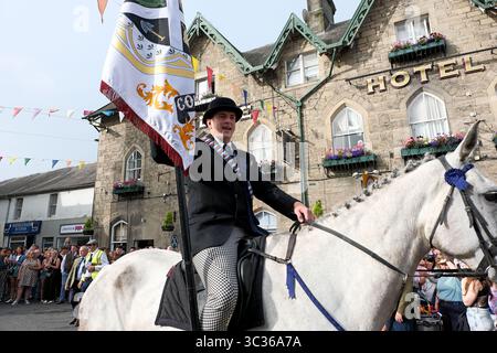 Langholm, UK. 25th July, 2025. Carrying the TownÕs Standard Cornet Ewan Alexander Patterson at the Town Hall during Langholm Common Riding on July 25, 2025 in Langholm, Scotland. A common riding is an equestrian tradition that mainly takes place in the Scottish Borders in Scotland where men and women ride out of the town and along its borders to commemorate the practices from the 13th and 15th centuries when there were frequent raids on the Anglo-Scottish border known as the Border Reivers. In Langholm this event dates back to 1759. ( Credit: Rob Gray/Alamy Live News Stock Photo