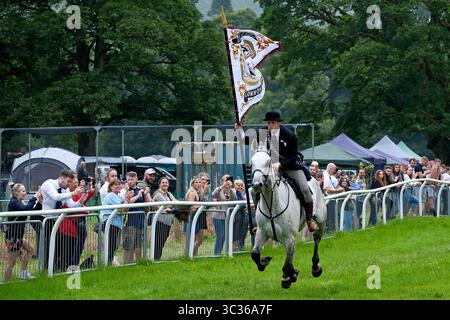 Langholm, UK. 25th July, 2025. The Cornet Ewan Alexander Patterson galloping round the race course on the CastleHolm during the towns common riding on July 25, 2025 in Langholm, Scotland. A common riding is an equestrian tradition that mainly takes place in the Scottish Borders in Scotland where men and women ride out of the town and along its borders to commemorate the practices from the 13th and 15th centuries when there were frequent raids on the Anglo-Scottish border known as the Border Reivers. In Langholm this event dates back to 1759. ( Credit: Rob Gray/Alamy Live News Stock Photo