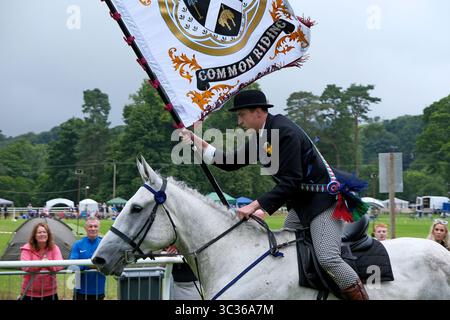 Langholm, UK. 25th July, 2025. The Cornet Ewan Alexander Patterson galloping round the race course on the CastleHolm during the towns common riding on July 25, 2025 in Langholm, Scotland. A common riding is an equestrian tradition that mainly takes place in the Scottish Borders in Scotland where men and women ride out of the town and along its borders to commemorate the practices from the 13th and 15th centuries when there were frequent raids on the Anglo-Scottish border known as the Border Reivers. In Langholm this event dates back to 1759. ( Credit: Rob Gray/Alamy Live News Stock Photo