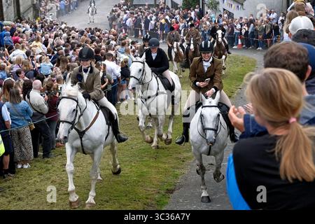 Langholm, UK. 25th July, 2025. Riders gallop up the Kirk Wynd during Langholm Common Riding on July 25, 2025 in Langholm, Scotland. A common riding is an equestrian tradition that mainly takes place in the Scottish Borders in Scotland where men and women ride out of the town and along its borders to commemorate the practices from the 13th and 15th centuries when there were frequent raids on the Anglo-Scottish border known as the Border Reivers. In Langholm this event dates back to 1759. ( Credit: Rob Gray/Alamy Live News Stock Photo