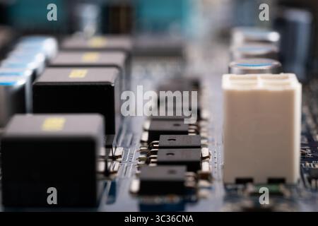 Close up of microchips in row on motherboard, electronic components Stock Photo