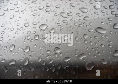 Close-up of Raindrops on Metallic Surface After Rainfall Stock Photo