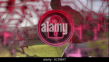 Neon red padlock icon hovering over soccer field under network overlay and sprinting in red jerseys Stock Photo