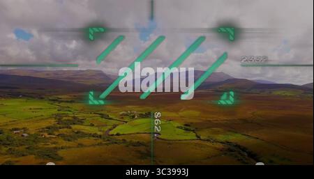 Displaying green heads-up display overlay with corner markers over rural valley with numeric data Stock Photo