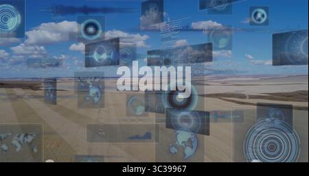 Displaying translucent HUD panels over plowed fields under blue sky with charts and map icons Stock Photo