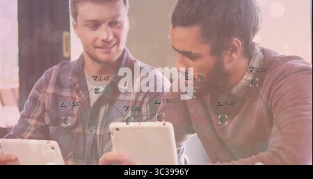 Collaborating men wearing plaid shirt and burgundy sweater using tablets at cafe on wooden table Stock Photo