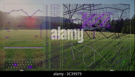 Displaying digital data overlaying grassland, with line chart, map grid and data columns Stock Photo