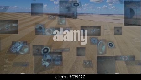 Floating digital panels displaying data and diagrams over arid plain, with map overlays Stock Photo