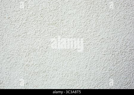 A view of a pebble dash style stucco wall texture, as a background. Stock Photo