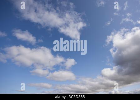 Blue sky with fluffy white clouds Stock Photo