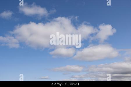 Blue sky with fluffy white clouds Stock Photo