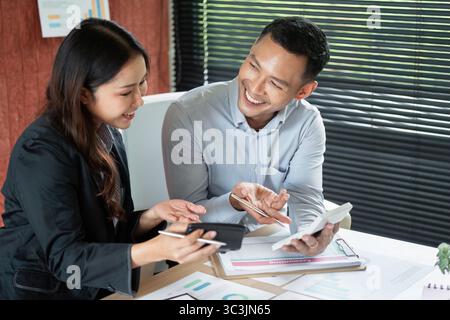 Collaborative Discussion Between Colleagues. Two professionals sharing insights and ideas in a modern office. Stock Photo