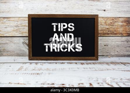 Tips and Tricks typography text on wooden blackboard Stock Photo