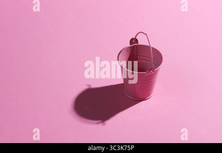 Empty mini pink bucket on pink background. Studio shot with shadow Stock Photo