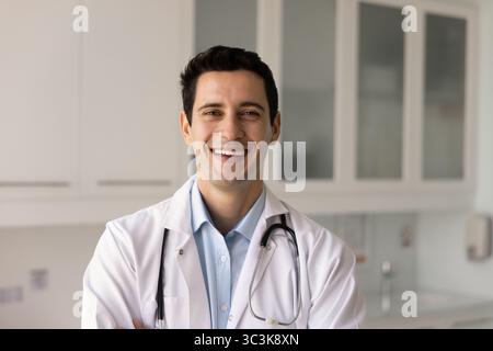 Happy handsome Latin physician man posing for portrait Stock Photo