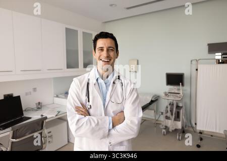 Happy successful ultrasound diagnosing medical specialist man posing in clinic Stock Photo