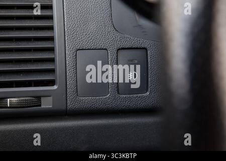 Close-up on the headlight switch control buttons and automatic adjust level dashboard of car in the vehicle. Auto service industry Stock Photo