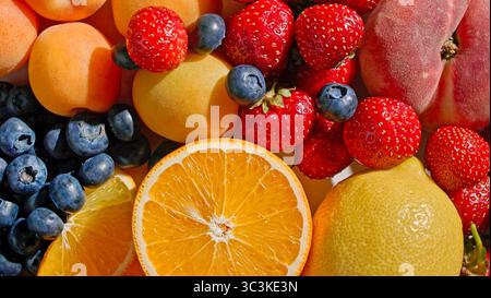 various colorful bright fresh fruits background, top view Stock Photo