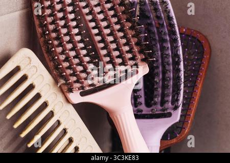 Hair brushes and combs. Set of plastic grooming tools on soft background. Closeup of everyday beauty accessories. Haircare concept personal hygiene. Stock Photo