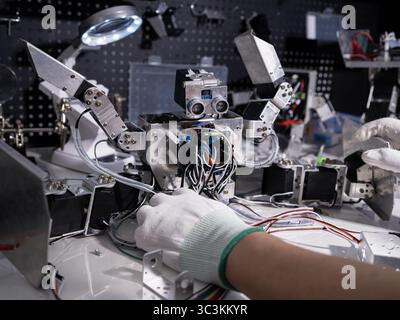 Repair the robot on the workbench Stock Photo