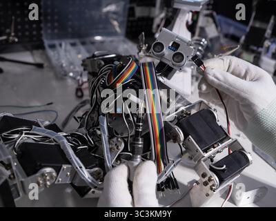 Repair the robot on the workbench Stock Photo