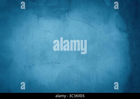 Background of a deep-colored concrete wall with blue hues for mock-up or template purposes Stock Photo