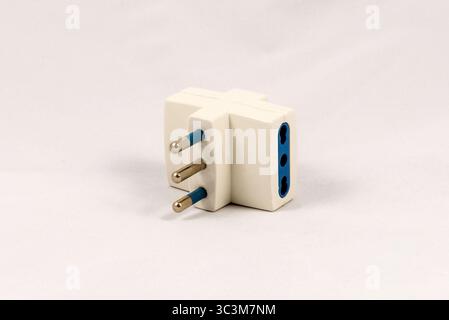 Three way EU electric plug adaptor, isolated on white background Stock Photo