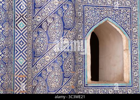 Colorful tiled wall with the arched window. Khiva. Uzbekistan. Stock Photo