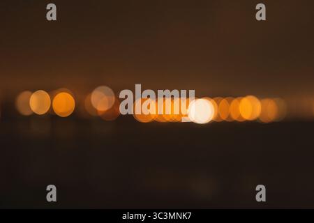 A mesmerizing display of abstract bokeh lights forms a magical atmosphere, blending warm hues and soft circles, creating a dreamy and mysterious visua Stock Photo