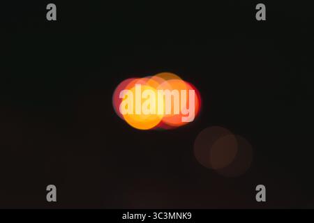Abstract image showcasing vibrant bokeh lights against a dark background. The colorful circles of light create a magical and dreamy effect, invoking a Stock Photo