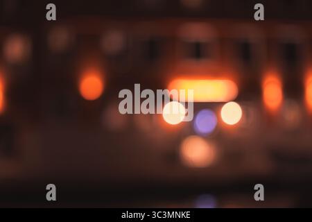 An enchanting display of abstract blurry lights creates a magical, warm glow in a dark setting, evoking feelings of wonder and tranquility through vib Stock Photo