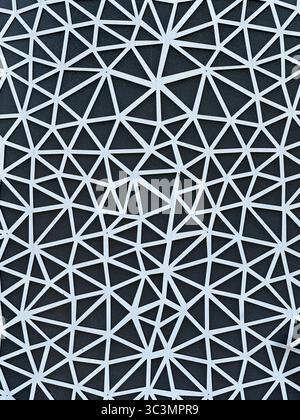Abstract geometric pattern featuring interconnected triangles in modern architectural design, highlighting symmetry and complexity against a contrasti Stock Photo