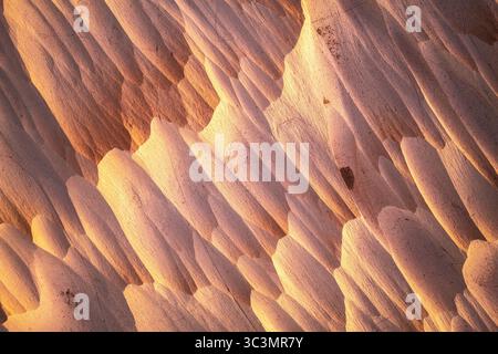 Stunning golden pumice stone formations in Catamarca, Argentina. Sunlight casts a warm glow on the textured surface, creating a breathtaking natural s Stock Photo