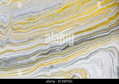 Abstract image showcasing a mesmerizing blend of yellow and gray tones in an acrylic paint background, featuring wavy lines and intricate patterns for Stock Photo