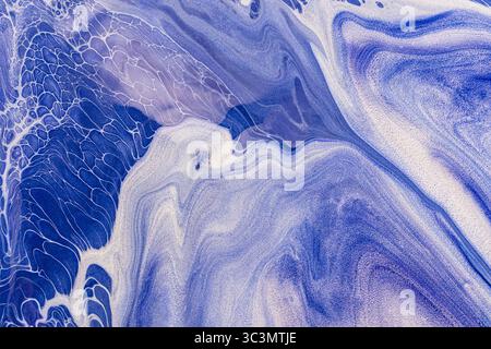 Beautiful abstract acrylic paint background featuring swirling blue tones. The fluid motion and intricate patterns create a captivating artistic expre Stock Photo