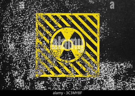 Radioactive sign on black textured surface. Radiological pollution Stock Photo