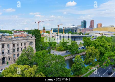 Berlin, Germany - May 31, 2025: Social Science Research building with greenery, waterways, and the Potsdamer Platz skyline in the background during a Stock Photo
