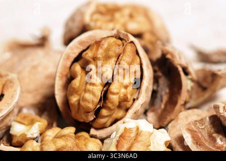 Whole and cracked walnuts and nutcracker Stock Photo
