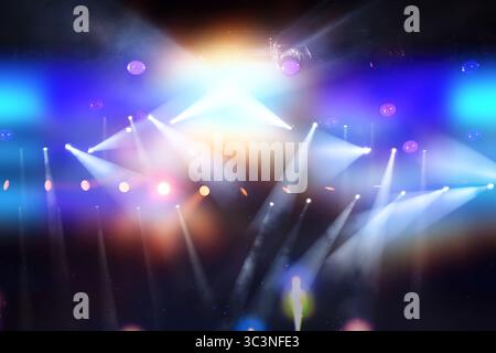 A stage with multiple spotlights and colorful lights illuminating the area. The lights are on and the stage is brightly lit, creating a vibrant and en Stock Photo