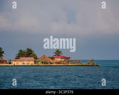 View towards The Lazy Lizard Bar and The Split at sunrise, Caye Caulker, Belize District, Belize Stock Photo