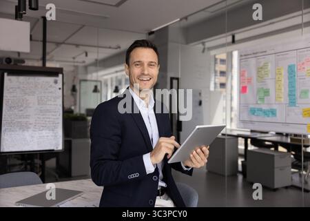 Businessman enjoy workflow, using innovative business technologies, portrait Stock Photo