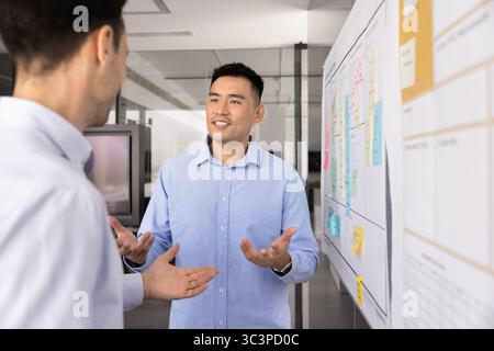 Two diverse professional men, project managers working on task Stock Photo