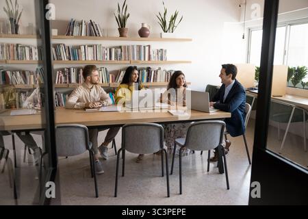 Group of diverse professionals engaged in collaborative meeting in office Stock Photo