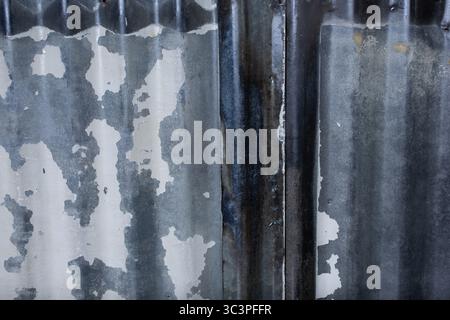 A closeup view of old rusty sheet metal surface with corrugated texture, as a background. Stock Photo