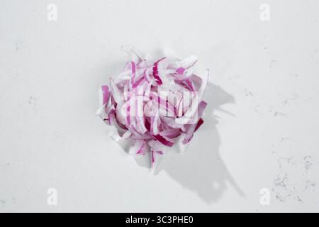 A top down view of a red onion slices, against a white background. Stock Photo