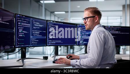 Portrait Of A Young Programmer Developing Software On His Computer Stock Photo